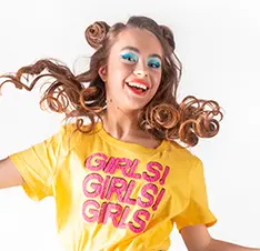 Smiling woman wearing yellow "GIRLS!" shirt