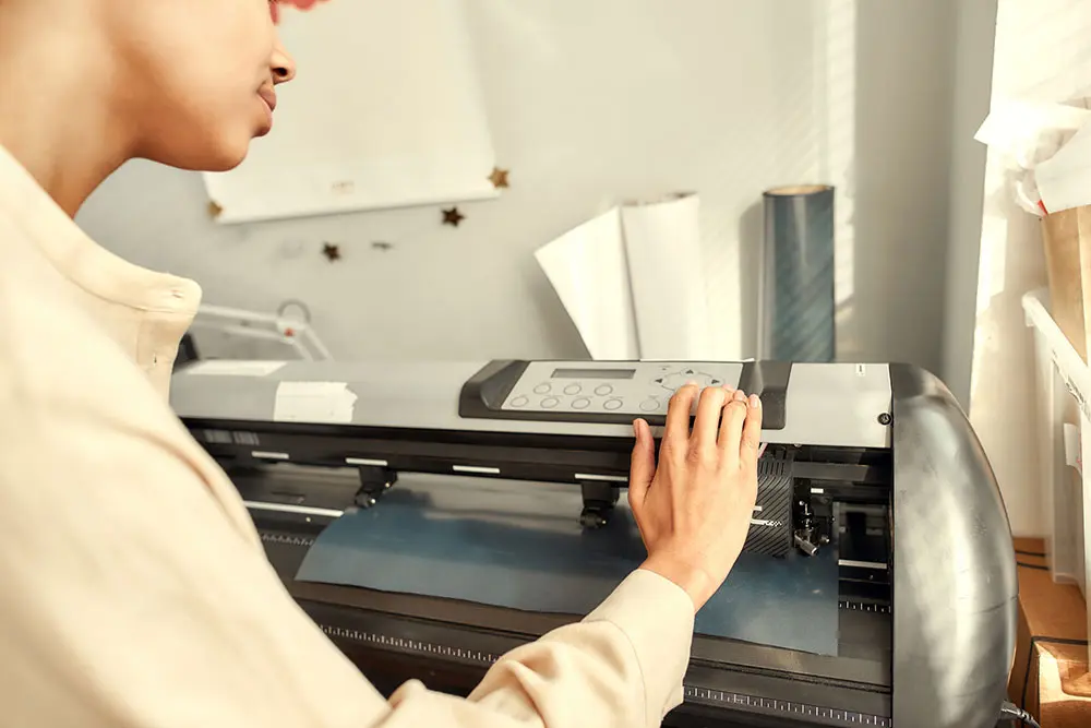 Person operating large-format printer plotter